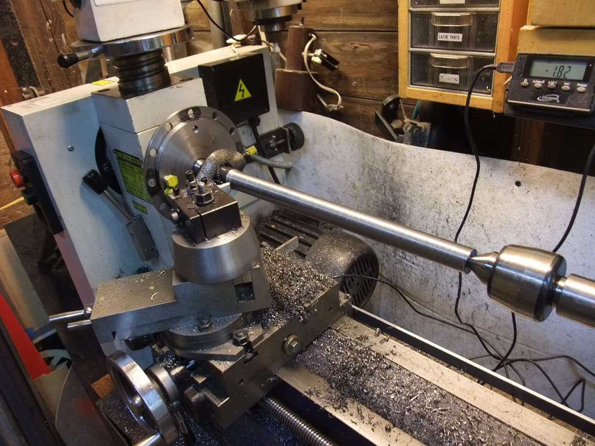 Turning a metal shaft on the lathe at DEE PEE Engineering